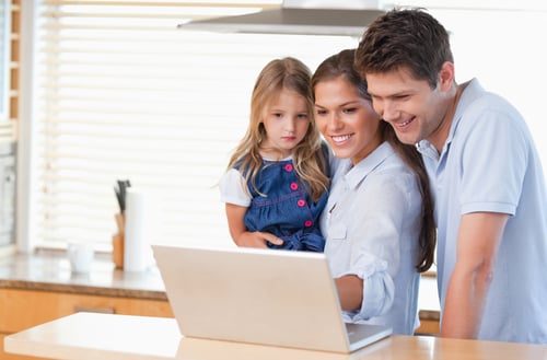 Family using a laptop in a kitchen