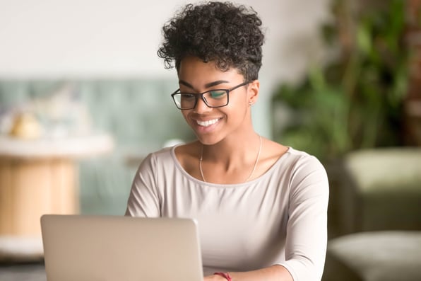 parent on computer filling enrollment paperwork