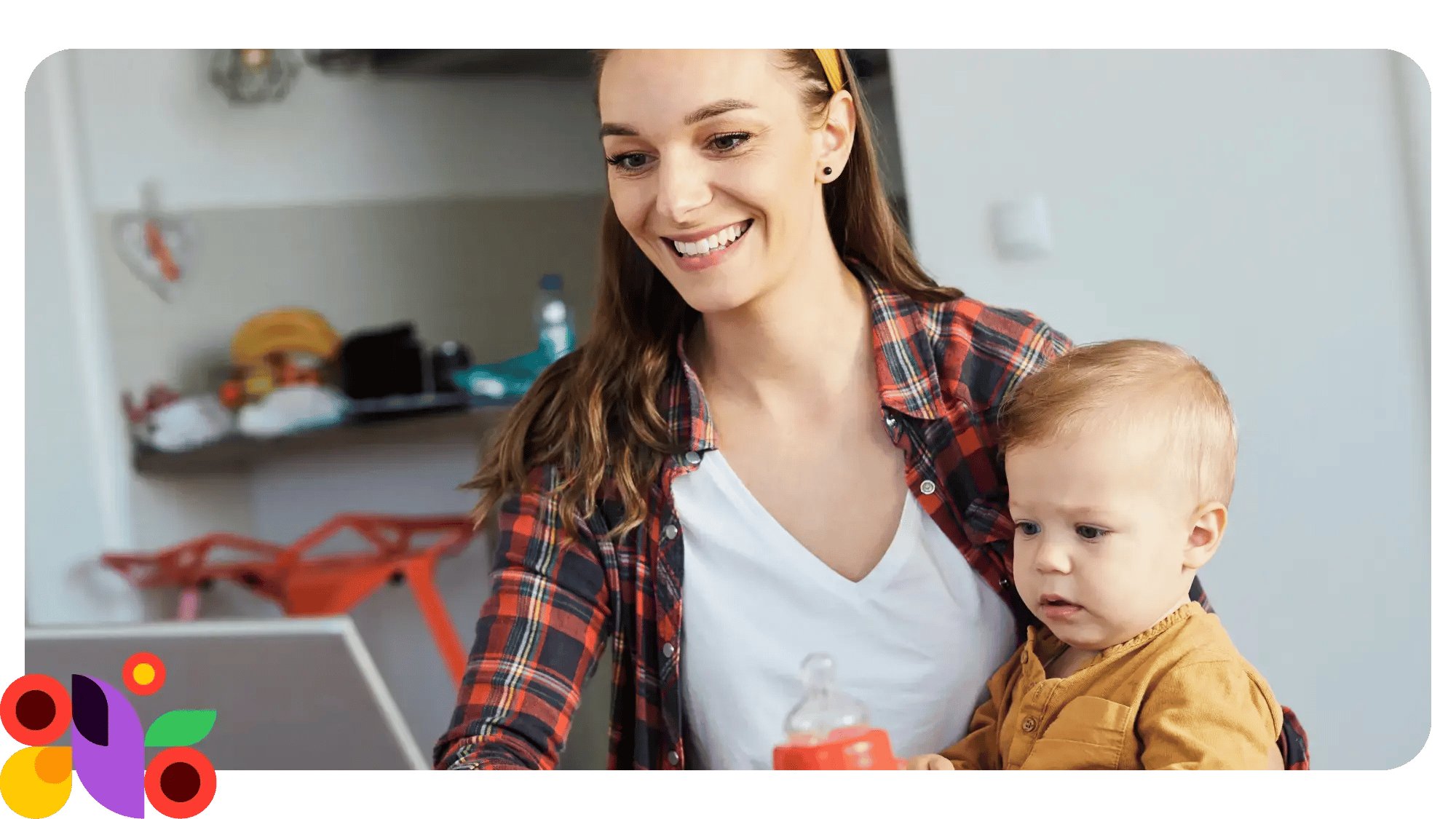 Parent using a laptop with child at home for childcare enrolment