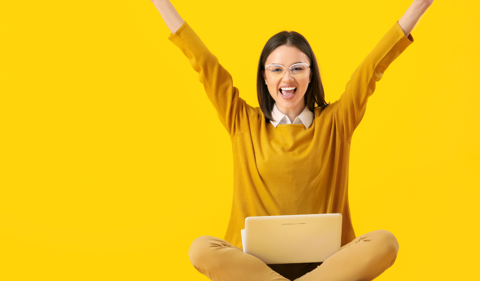 woman with laptop cheering: multi-touch marketing attribution